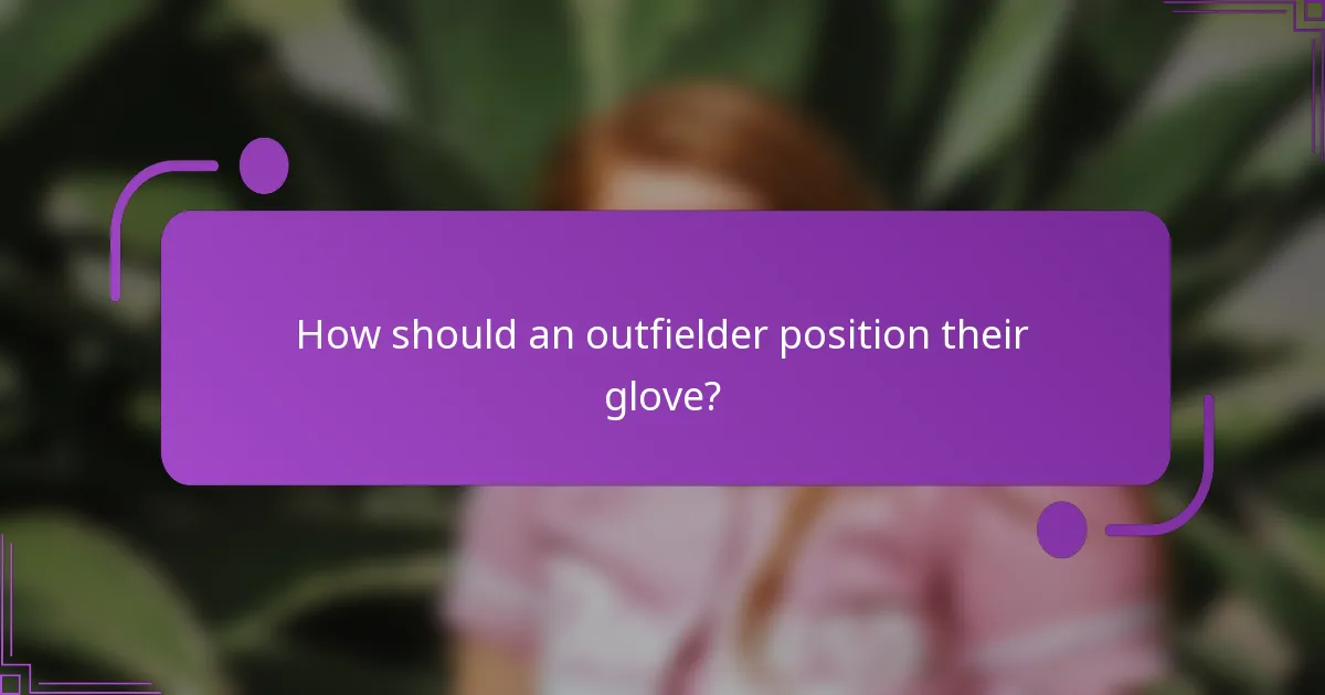 How should an outfielder position their glove?